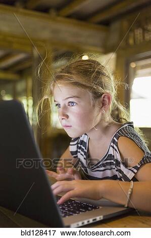 Caucasian girl using laptop View Large Photo Image Stock Photo - Caucasian girl using laptop. Fotosearch