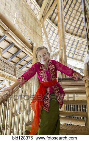 Stock Photography - Caucasian girl wearing traditional Hindu clothing on stairs. Fotosearch