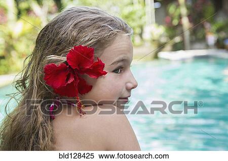 Stock Photography - Caucasian girl with hibiscus flower in hair. Fotosearch