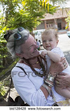Stock Photo - Caucasian grandmother holding happy baby boy. Fotosearch