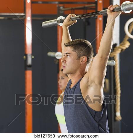 Caucasian man working out in gym View Large Photo Image Stock Image - Caucasian man working out in gym . Fotosearch