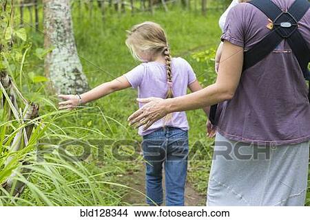 Picture - Caucasian mother and children walking in forest. Fotosearch