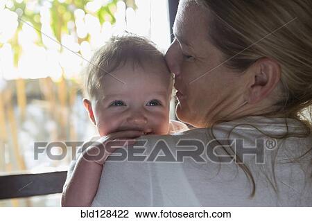 Stock Image - Caucasian mother holding baby boy. Fotosearch