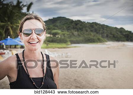 Caucasian woman smiling on beach View Large Photo Image Stock Image - Caucasian woman smiling on beach. Fotosearch