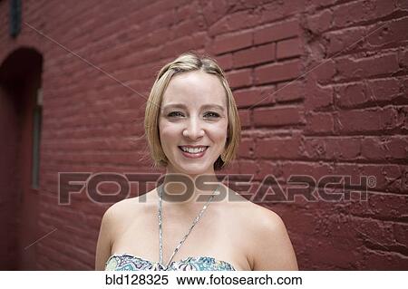 Stock Photography - Caucasian woman smiling on city street. Fotosearch