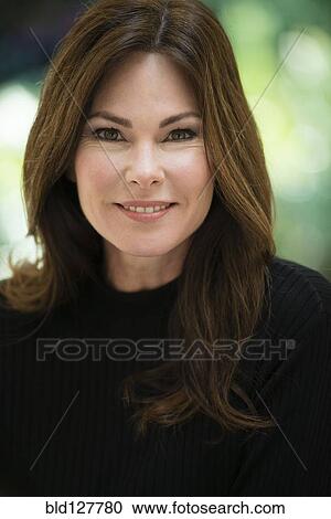 Stock Image - Caucasian woman smiling outdoors. Fotosearch