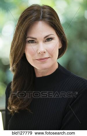 Stock Photo - Caucasian woman smiling outdoors. Fotosearch