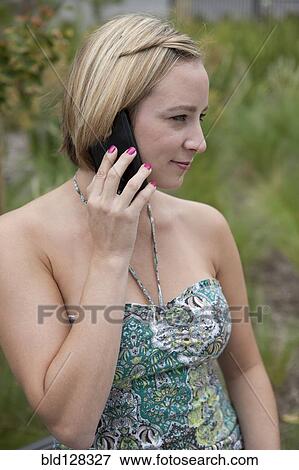 Stock Photo - Caucasian woman talking on cell phone. Fotosearch