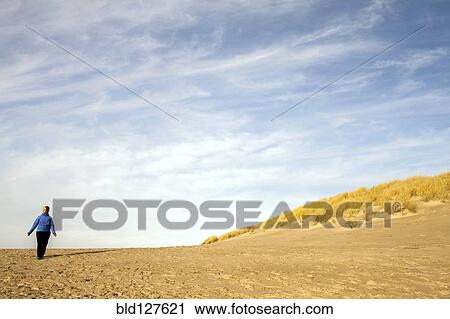 Caucasian woman walking on beach View Large Photo Image Stock Image - Caucasian woman walking on beach. Fotosearch
