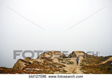 Caucasian woman walking on sand dunes View Large Photo Image Stock Photograph - Caucasian woman walking on sand dunes. Fotosearch