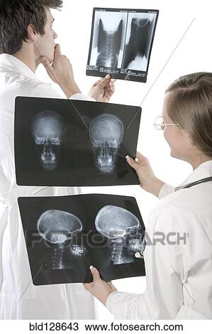 Doctors examining x-rays in hospital View Large Photo Image Stock Image - Doctors examining x-rays in hospital. Fotosearch