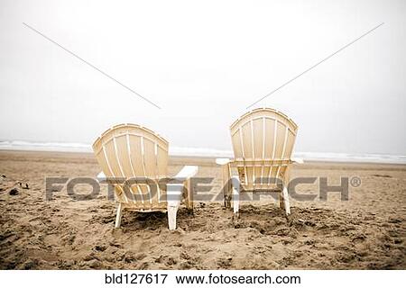 Stock Photo - Empty lawn chairs on beach. Fotosearch