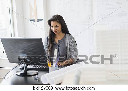 Stock Photo - Hispanic architect working in office. Fotosearch