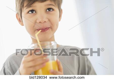 Hispanic boy drinking juice with straw View Large Photo Image Picture - Hispanic boy drinking juice with straw. Fotosearch