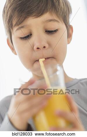 Hispanic boy drinking juice with straw View Large Photo Image Stock Image - Hispanic boy drinking juice with straw. Fotosearch