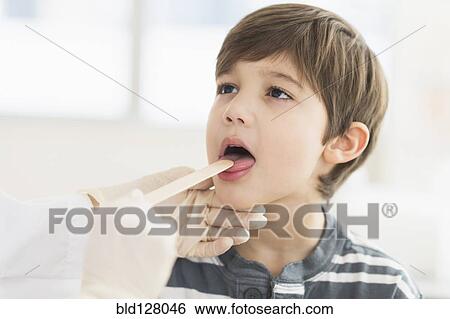 Stock Photograph - Hispanic boy getting a check up at doctor's office. Fotosearch