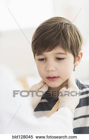 Hispanic boy getting a checkup at doctor's office View Large Photo Image Stock Photography - Hispanic boy getting a checkup at doctor's office. Fotosearch