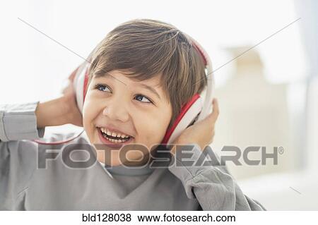Hispanic boy listening to headphones View Large Photo Image Stock Photo - Hispanic boy listening to headphones. Fotosearch