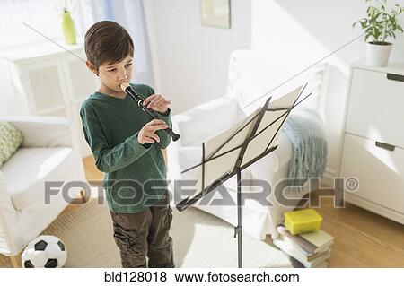 Hispanic boy practicing recorder in living room View Large Photo Image Stock Photo - Hispanic boy practicing recorder in living room. Fotosearch