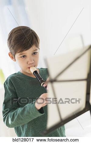 Stock Photo - Hispanic boy practicing recorder . Fotosearch