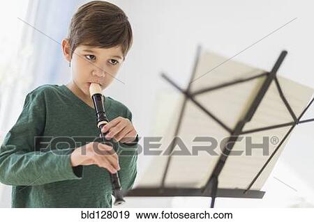 Stock Photo - Hispanic boy practicing recorder . Fotosearch