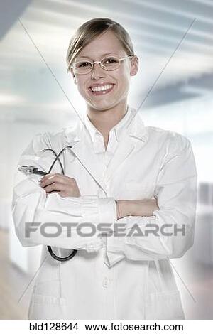 Hispanic doctor smiling in hospital View Large Photo Image Picture - Hispanic doctor smiling in hospital. Fotosearch