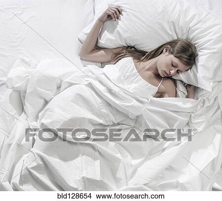 Hispanic woman asleep in bed View Large Photo Image Picture - Hispanic woman asleep in bed. Fotosearch
