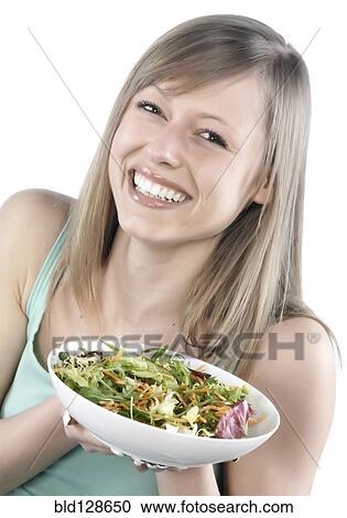 Stock Image - Hispanic woman eating salad. Fotosearch
