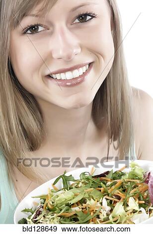 Hispanic woman eating salad View Large Photo Image Stock Photo - Hispanic woman eating salad. Fotosearch