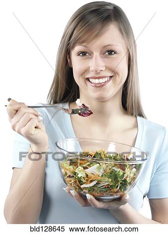 Stock Photography - Hispanic woman eating salad. Fotosearch