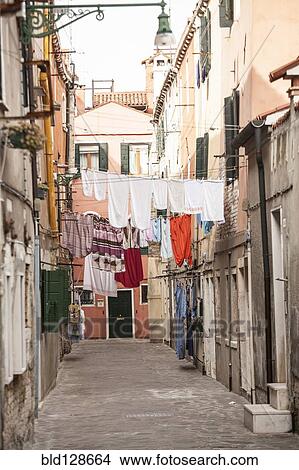 Picture - Laundry hanging over village street. Fotosearch