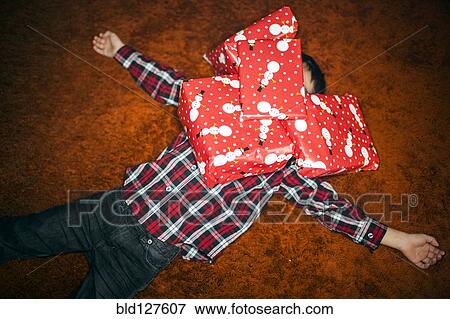 Mixed race boy buried in Christmas gifts View Large Photo Image Stock Photo - Mixed race boy buried in Christmas gifts. Fotosearch