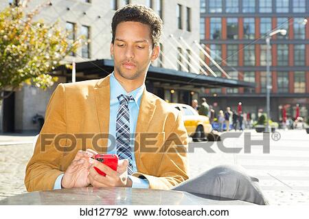 Mixed race businessman using cell phone outdoors View Large Photo Image Stock Image - Mixed race businessman using cell phone outdoors. Fotosearch