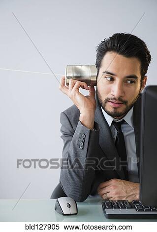 Mixed race businessman using tin can telephone View Large Photo Image Stock Photography - Mixed race businessman using tin can telephone. Fotosearch