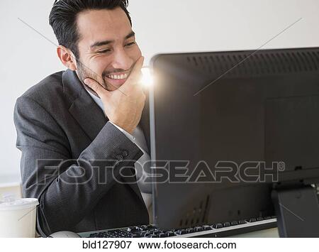 Mixed race businessman working in office View Large Photo Image Stock Photo - Mixed race businessman working in office. Fotosearch