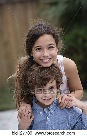 Stock Photo - Mixed race children smiling together. Fotosearch