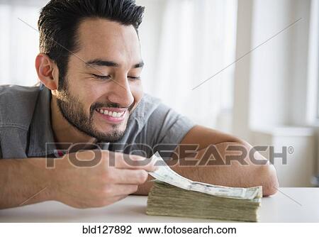 Mixed race man counting stack of money View Large Photo Image Stock Image - Mixed race man counting stack of money. Fotosearch