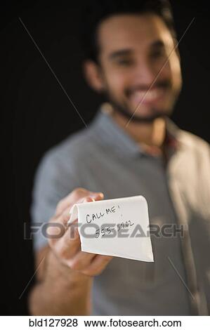 Stock Photo - Mixed race man giving out phone number on napkin. Fotosearch