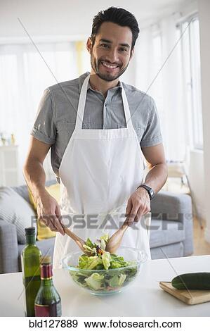 Mixed race man tossing salad at table View Large Photo Image Stock Photo - Mixed race man tossing salad at table. Fotosearch