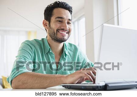 Mixed race man using laptop View Large Photo Image Stock Photography - Mixed race man using laptop. Fotosearch