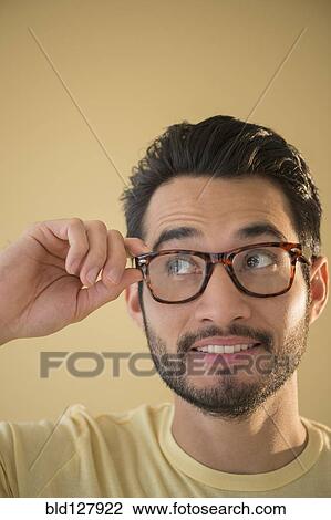 Stock Image - Mixed race man wearing glasses. Fotosearch
