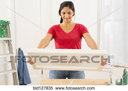 Mixed race woman examining window pane View Large Photo Image Stock Photography - Mixed race woman examining window pane. Fotosearch