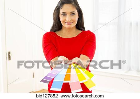Mixed race woman holding paint swatches View Large Photo Image Stock Image - Mixed race woman holding paint swatches. Fotosearch