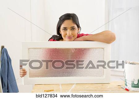 Mixed race woman making window pane View Large Photo Image Picture - Mixed race woman making window pane. Fotosearch