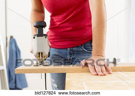 Mixed race woman using jigsaw View Large Photo Image Picture - Mixed race woman using jigsaw. Fotosearch