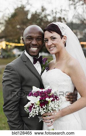 Newlywed couple hugging outdoors View Large Photo Image Stock Photography - Newlywed couple hugging outdoors. Fotosearch