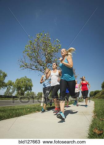 Stock Image - People jogging together outdoors. Fotosearch
