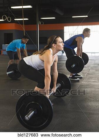 People lifting weights in gym View Large Photo Image Stock Image - People lifting weights in gym. Fotosearch