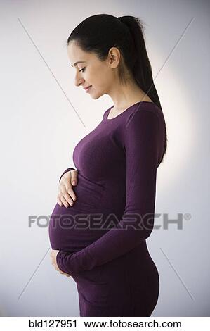 Pregnant Caucasian woman holding stomach View Large Photo Image Stock Image - Pregnant Caucasian woman holding stomach. Fotosearch