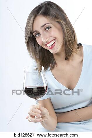 Smiling woman having glass of wine View Large Photo Image Stock Photo - Smiling woman having glass of wine. Fotosearch